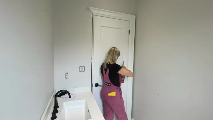 Trim excess: Trim the excess wallpaper at the top and bottom with a sharp exacto knife and straight edge.