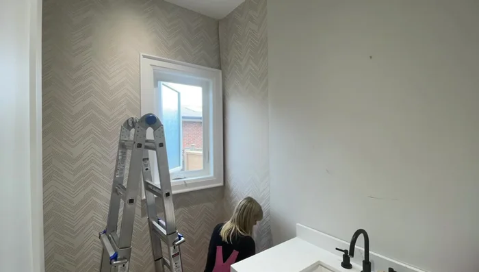 Handle tricky areas: Follow the same principles (paste, hang, smooth, trim) for areas around toilets and sinks, making relief cuts to wrap the wallpaper around fixtures.