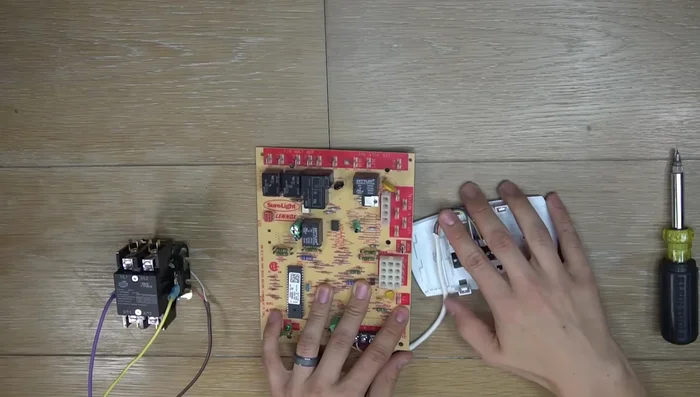 Connect the two-wire thermostat wire (typically brown, but can vary) from the control board to the outdoor air conditioner unit's contactor. Connect to 'Y' and 'C' on the control board; the order doesn't matter.