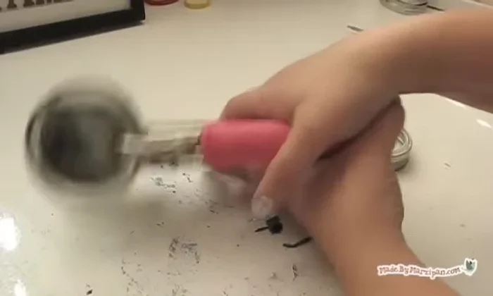 Remove the disc from the jar lid. Create two holes on top using a hole punch (or hammer and nail).