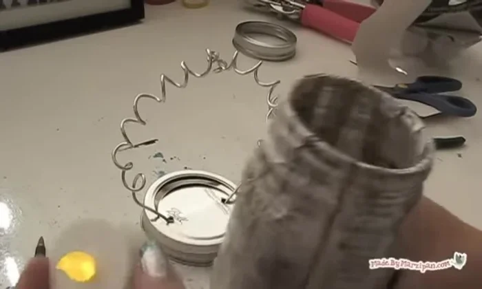 Add an electric tealight and screw on the lid. Hang the lanterns.