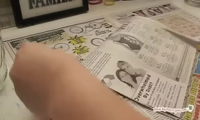 Cut newspaper or tissue paper into strips (about 1.5 inches wide). Remove any colored images; use only black and white.