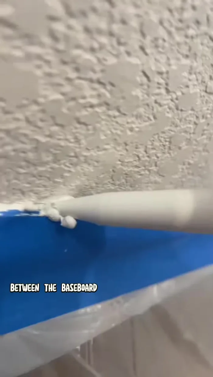 Caulk: Apply caulk along the baseboard and wall edges, carefully removing excess to avoid lines. A wet rag helps clean up excess caulk.