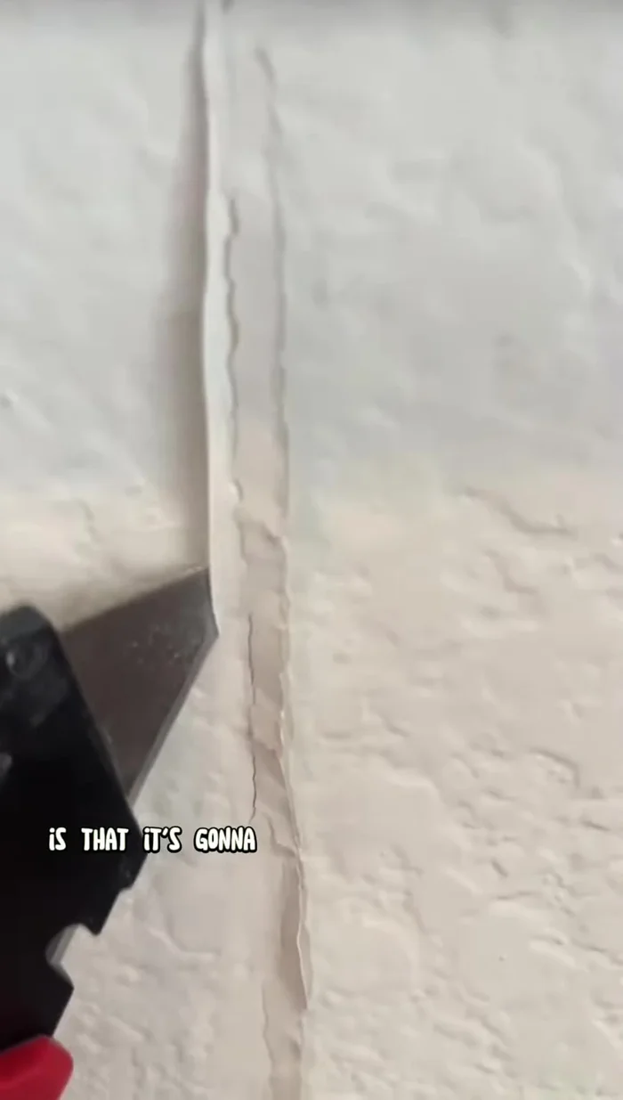 Prepare the crack: Use a utility knife to create a beveled edge along the crack, opening it up for better mud application.