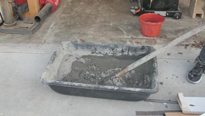 Cover the form with plastic and let the concrete cure for 24-48 hours.