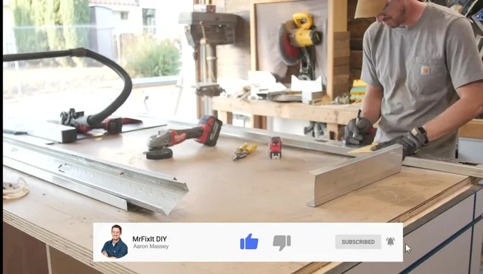 Build the fire pit base frame using metal two by fours, cutting and securing them with self-tapping metal screws and clamps.