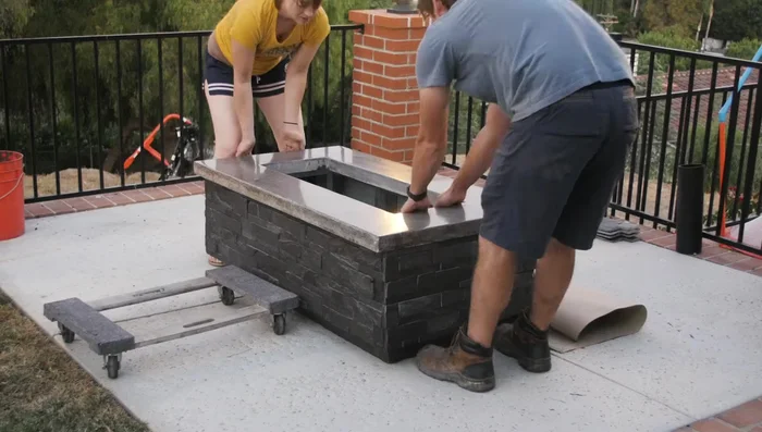 Turn on the gas, fill the fire tray with fire glass, and light the fire pit.