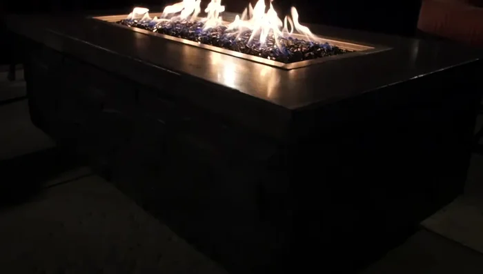 Turn on the gas, fill the fire tray with fire glass, and light the fire pit.