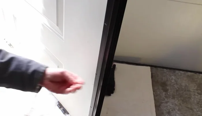 Attach the door sweep to the door using the screws, starting from the center and working outwards.
