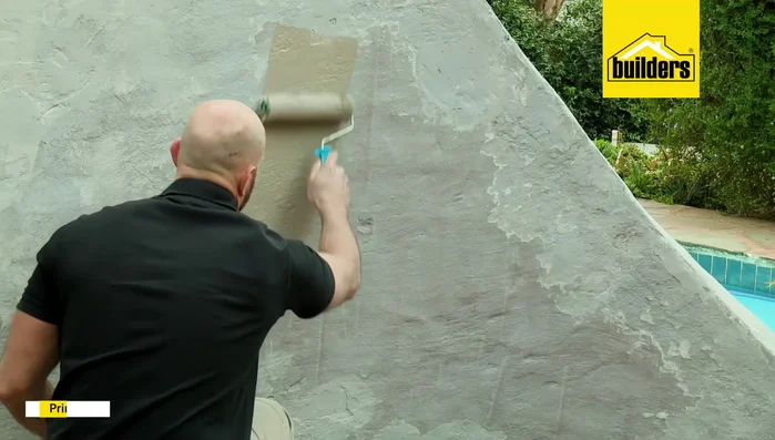 Paint the entire wall with two coats of a 5-in-1 paint (primer, waterproofer, undercoat, topcoat, and acrylic sealer), allowing four hours of drying time between coats.
