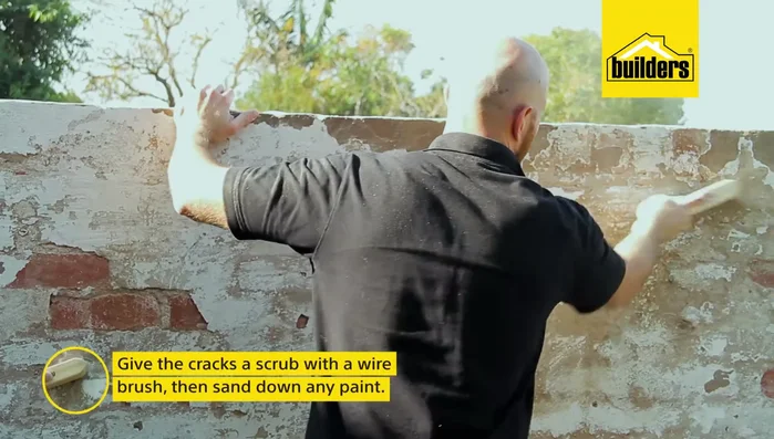 Scrub cracks with a wire brush and sand down any remaining paint.
