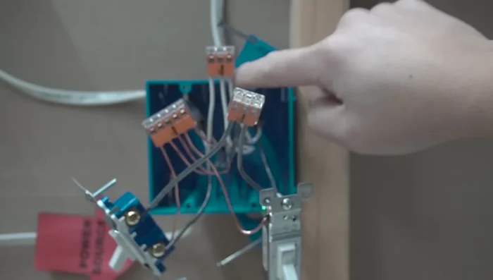 Tuck wires neatly into the junction box and secure the switches.