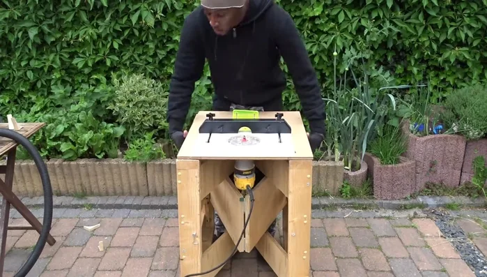 Transform the worktable into a router table and use a straight bit to create the cups.