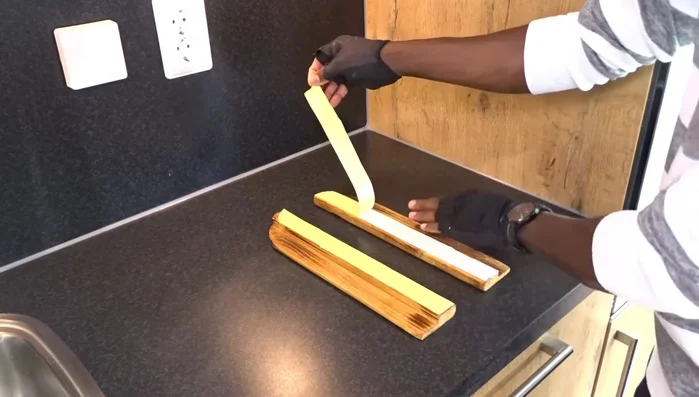 Attach the holders to the cabinets using double-sided tape (for demonstration) or screws.