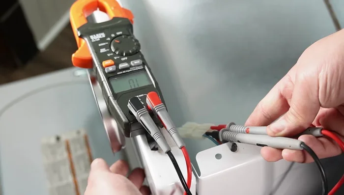 Remove the dryer front panel and inspect/replace the door switch, idler pulley and belt.