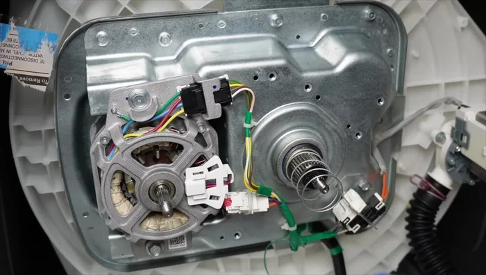 Reinstall the clutch spring, white clutch, and black pulley. Lubricate with silicone-based grease.