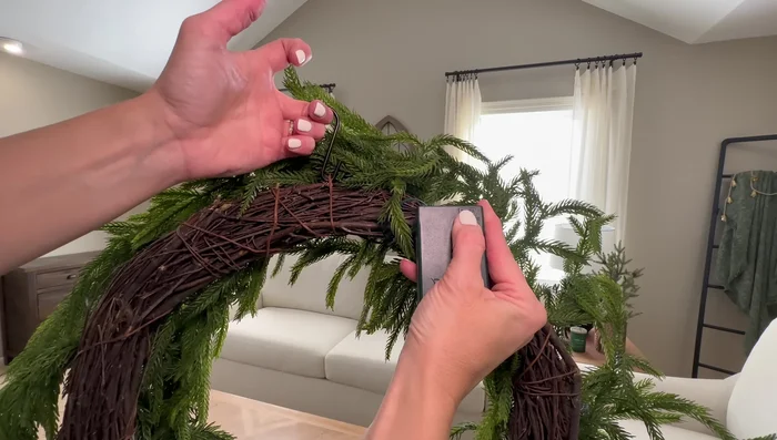 Hang wooden snowflakes above an armchair using picture hangers.