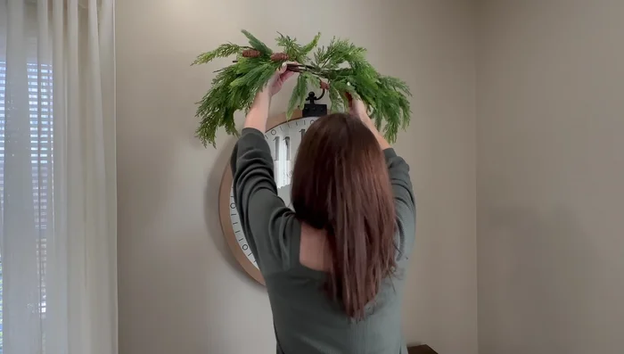 Create a Christmas arrangement on a cabinet using DIY vessels, stems, faux branches, and berry picks.