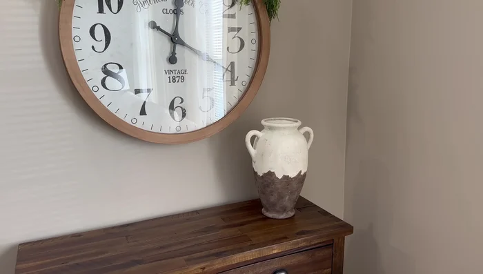 Create a Christmas arrangement on a cabinet using DIY vessels, stems, faux branches, and berry picks.