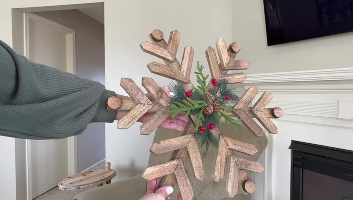 Hang wooden snowflakes above an armchair using picture hangers.