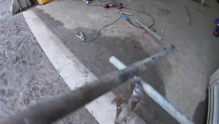 Cut and weld the cross-piece across the bottom of the gate to add stability. Weld the tube section on the bottom for the hinge.