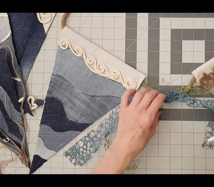 Tie lace ribbon and add starfish (optional) between pennants.