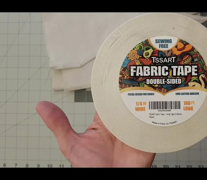 Sew or glue the seam allowance. A zigzag stitch (6.5 mm width) is recommended if sewing. Alternatively, use fabric glue, Mod Podge, or double-sided tape.