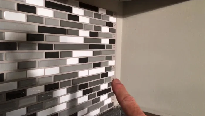 For corners, create a template to ensure a seamless wraparound effect. Measure and cut tiles to fit the template precisely, accounting for wall imperfections.
