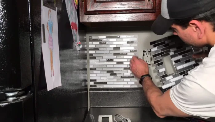 Remove the protective plastic film from the tiles after application.