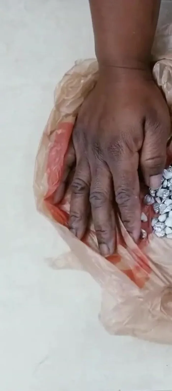 Glue a smaller mirror to the top of the lid and fill in the gaps with pebbles.