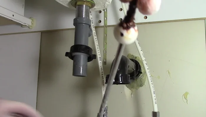 Clean the hole where the pivot rod goes with a paper towel.