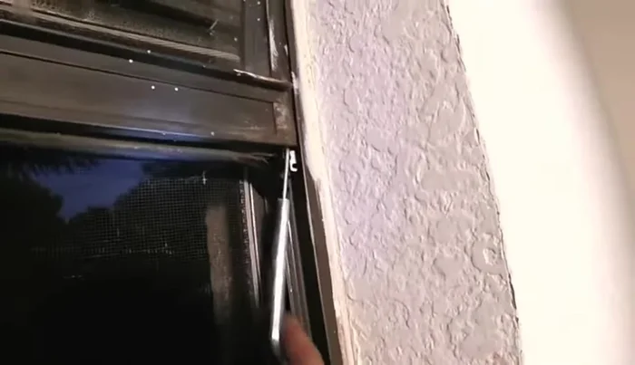 Slowly raise the window until the balance hook snaps into place.