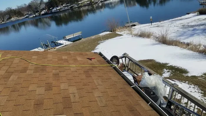 Install one row of ice shield at the bottom, cutting back the first tab to avoid bulk.