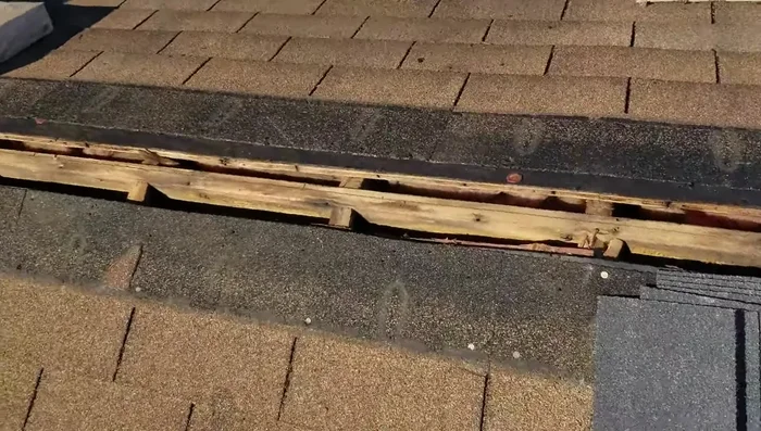 Remove an extra row of old shingles above the ridge if installing a new ridge vent.