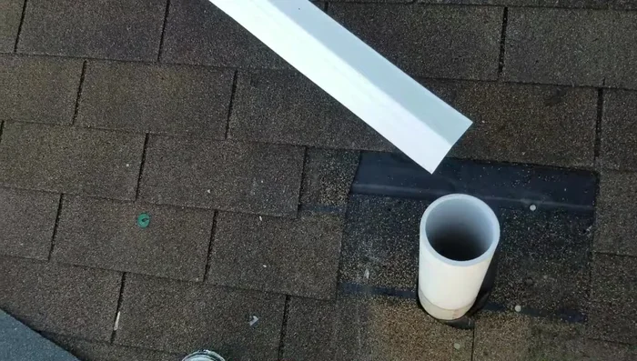Install new flashing around pipes, and clean excess material for a flush fit.