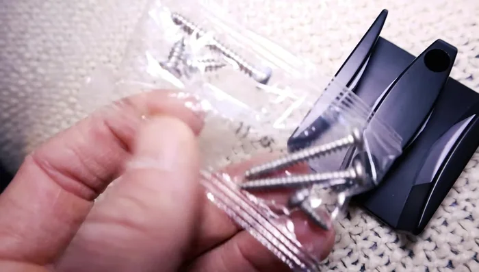 Install the bottom rail bracket, ensuring the glass doors are separated and on their tracks.