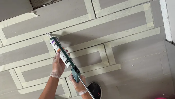 Smooth the grout using your finger (wearing a latex glove) to ensure even coverage and remove any excess. Wipe away excess grout immediately with a sponge or wipe.