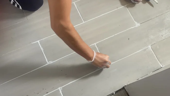 If necessary, touch up any remaining cracks with a small amount of grout and smooth with your finger, then clean immediately.