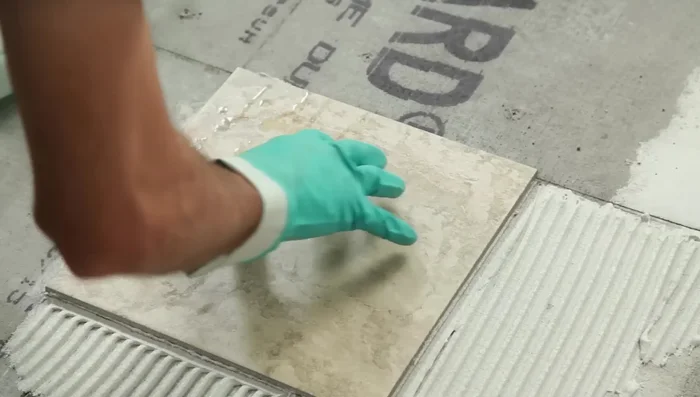 Finish laying all the full tiles in one quadrant, keeping the line straight, then finish the other three quadrants. Let the mortar harden for 24 hours.