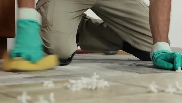 Finish laying all the full tiles in one quadrant, keeping the line straight, then finish the other three quadrants. Let the mortar harden for 24 hours.