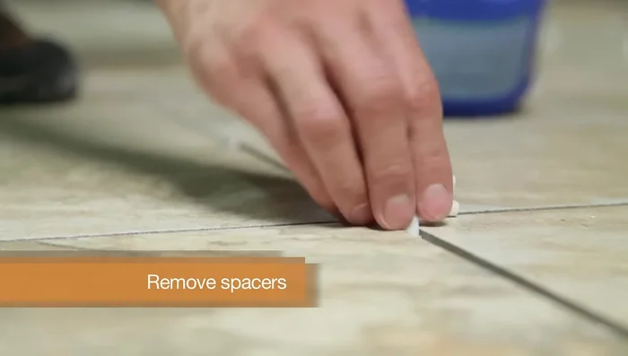 Wipe the tiles with a barely damp sponge to remove residue. Buff with a dry cloth to remove haze. Mist with water twice a day for 3 days to help grout cure.