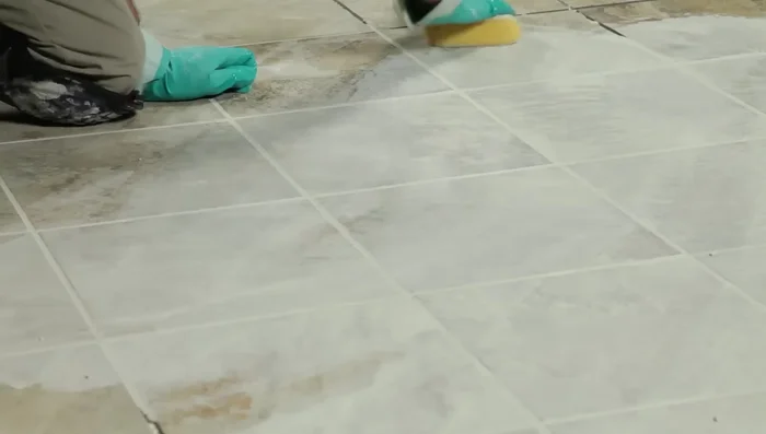 Wipe the tiles with a barely damp sponge to remove residue. Buff with a dry cloth to remove haze. Mist with water twice a day for 3 days to help grout cure.