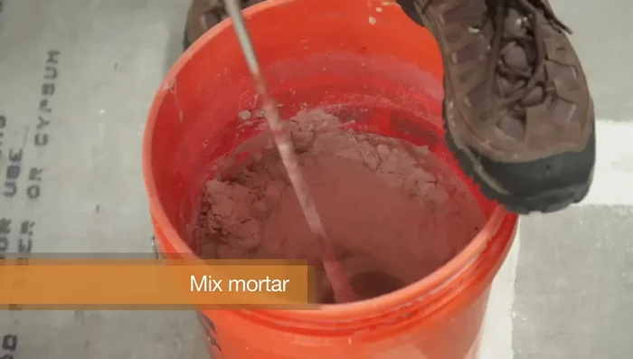 Test your mortar by laying a tile flat, twisting slightly, and checking if the back is completely covered.