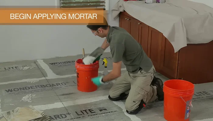 Finish laying all the full tiles in one quadrant, keeping the line straight, then finish the other three quadrants. Let the mortar harden for 24 hours.