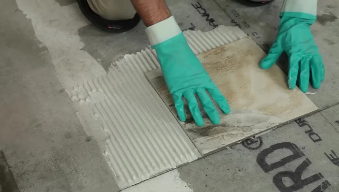 Test your mortar by laying a tile flat, twisting slightly, and checking if the back is completely covered.