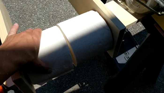 Determine spacing for toilet paper rolls. Place rolls side-by-side to determine the necessary spacing and measure the distance between the outer edges of the rolls for the back support.