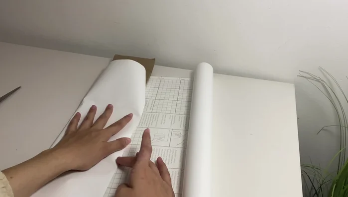 Apply adhesive paper to cover the cardboard.