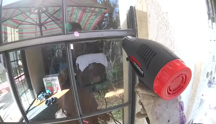 Carefully remove the broken glass pane using a stick or putty knife.