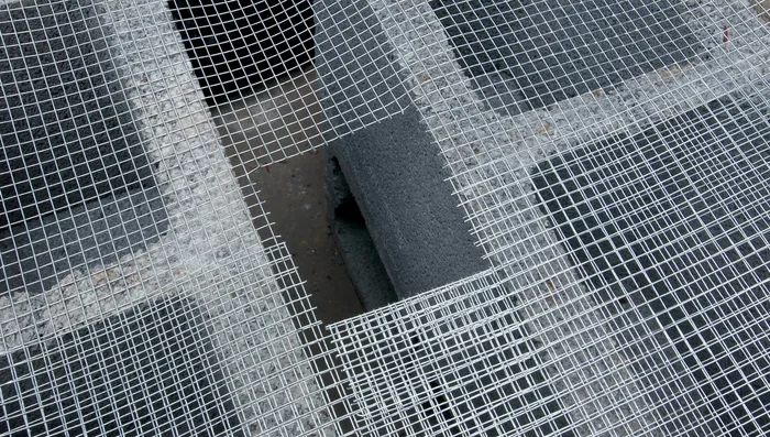 Position the planters: Place the largest planter on top of the cinder blocks, cutting a hole for the pump tubing. Position the smaller planters on the sides, using stones and driftwood for support and height.