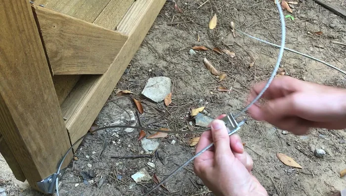 Tighten the bottom cable clamp.